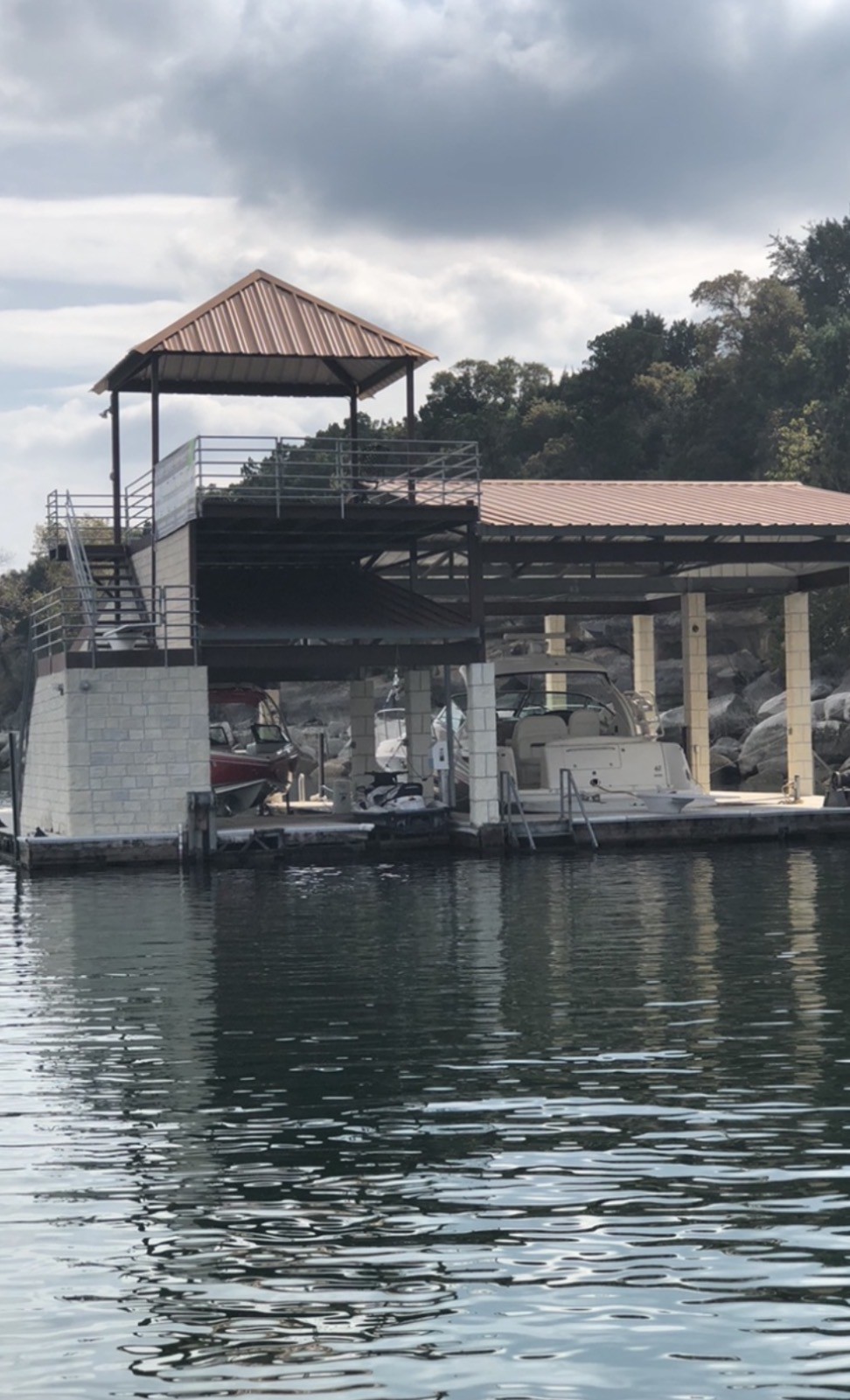 Finished custom dock with copper-colored roof and upper sundeck